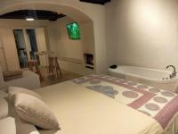 A bed or beds in a room at Casa Cueva El Naranjo Rocabella