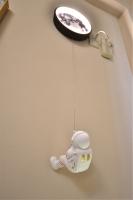 a toy astronaut hanging on a wall with a clock at Piau Po 21 Inn in Taitung City