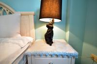 a lamp sitting on a night stand next to a bed at Piau Po 21 Inn in Taitung City