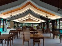 una sala da pranzo con tavoli, sedie e finestre di Villa Marilyn Resort and Hotel a Coron