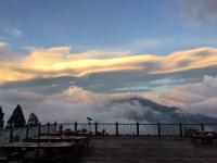 a cloudy sky with picnic tables on a deck at Naluwan Villa in Ren&#39;ai