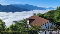 a house in the mountains with a view of the clouds at Naluwan Villa in Ren&#39;ai