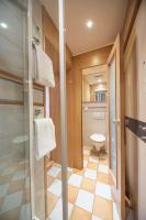 a small bathroom with a toilet and a shower at ACHAT Sternhotel Bonn in Bonn