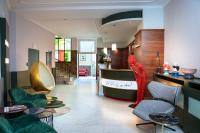 a lobby with chairs and a counter in a building at ACHAT Sternhotel Bonn in Bonn