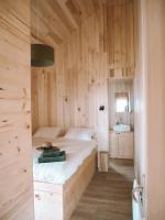 a bedroom with a bed in a wooden wall at Domaine St-Amand in Saint-Amand-de-Coly