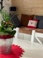 a table with a potted plant and a couch at Au-Doux-Altic chalet romantique avec JACUZZI ET SAUNA in Métabief