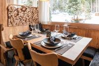 een houten tafel met glazen en borden erop bij Typically Swiss Hotel Ermitage in Kandersteg