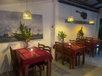 una sala da pranzo con tavoli, sedie e luci di Lonely Beach Pool Resort a Ko Chang