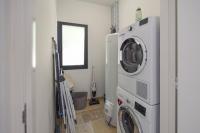 a laundry room with a washer and dryer at Domaine d&#39;Essendiéras in Saint-Médard-dʼExcideuil