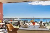 a dining room with a table with a view of the ocean at Hotel Miba in Salobreña