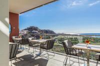 a balcony with tables and chairs and a view of the ocean at Hotel Miba in Salobreña
