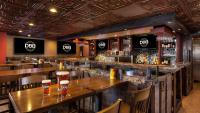 a bar with wooden tables and glasses of beer at Condos at Canyons Resort by White Pines in Park City