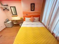 a yellow bed in a room with a window at Tz Shin Resort Hostel in Kenting