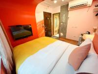 a bedroom with a large bed and a tv at Tz Shin Resort Hostel in Kenting