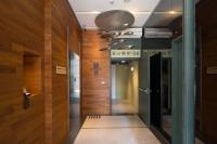 a hallway with wood paneling and a hallway with a door at Chaiin Hotel - Dongmen in Taipei