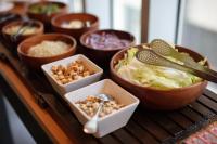 a table with bowls of food on a counter at Chaiin Hotel - Dongmen in Taipei