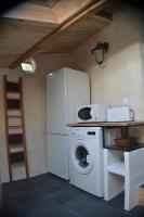 a kitchen with a refrigerator and a washing machine at Gîte &#39;An Kay Ou&#39; - Le Grand Barry in Pontaix