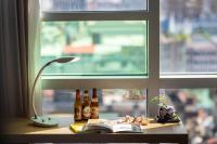 a table with bottles and a lamp and a window at Chaiin Hotel - Dongmen in Taipei