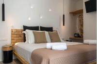 a bedroom with a large bed with white pillows at Studios Alsos in Naxos Chora