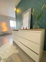 a white dresser in a room with a mirror at COSY in Clermont-Ferrand