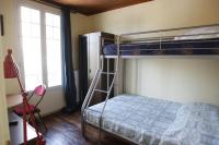 a bedroom with a bunk bed with a ladder and a window at RENT APPART - Colombes in Colombes