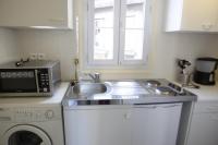 a kitchen with a sink and a microwave at RENT APPART - Colombes in Colombes