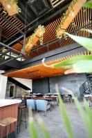 a restaurant with tables and chairs in a room at H Hotel El Nido - Vegan Friendly Hotel Managed by H Hospitality Group in El Nido