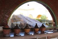 a group of pots sitting on a table next to a window at Artika Wadi Kiki Hotel in Aswan