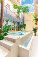 a swimming pool in the middle of a building at AmazINN Places Casco Viejo Pool and Rooftop XIV in Panama City