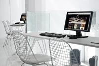 a desk with a computer monitor and two chairs at Axel Hotel Barcelona - Adults Only in Barcelona