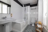 a white bathroom with a sink and a toilet at Hôtel Madeleine Haussmann in Paris