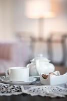 a table with two cups and a plate of food at Hotel Rural Monte da Provença in Elvas