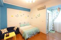 a bedroom with a bed and a couch at Hualien Lidu House in Hualien City