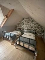 Łóżko lub łóżka w pokoju w obiekcie Gîte Les Roches d'Étigues