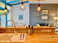 a kitchen with pendant lights and a counter top at Le Jardin Des Sacres - HyperCentre Cathédrale in Reims