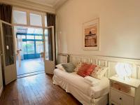 a bedroom with a bed and a door to a hallway at Le Jardin Des Sacres - HyperCentre Cathédrale in Reims