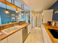 a kitchen with a sink and a counter top at Le Jardin Des Sacres - HyperCentre Cathédrale in Reims