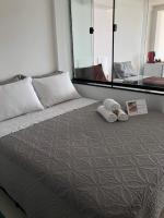 a bedroom with a large bed with two pillows at Suítes Luxo Marambaia- Epic House in Rio de Janeiro