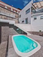 a swimming pool in front of a house at Suítes Luxo Marambaia- Epic House in Rio de Janeiro