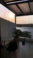 a room with a table and a view of the water at Suítes Luxo Marambaia- Epic House in Rio de Janeiro