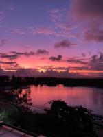 a sunset over a body of water with at Suítes Luxo Marambaia- Epic House in Rio de Janeiro