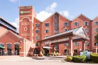 a large red brick building with a hotel at Holiday Inn Lincoln by IHG in Lincoln