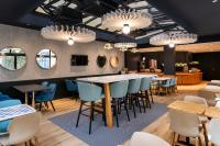 a restaurant with a bar with blue chairs and tables at ibis Paris Bastille Faubourg St Antoine in Paris