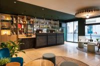 a restaurant with a bar and tables and chairs at ibis Paris Bastille Faubourg St Antoine in Paris