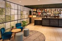 a restaurant with blue chairs and a counter at ibis Paris Bastille Faubourg St Antoine in Paris