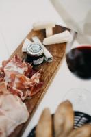 een snijplank met vlees en een fles wijn bij Hôtel & Appartements Monsigny in Nice