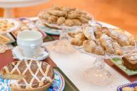 a table with a bunch of pastries and other desserts at Hotel Poseidon in Positano