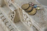 a group of coins on a stone pillar at Hotel Poseidon in Positano