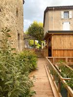 a wooden walkway in front of a building at Gîte : La vieille bâtisse. in La Baume-Cornillane