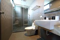a bathroom with a toilet and a sink and a shower at Dear B&amp;B in Hualien City